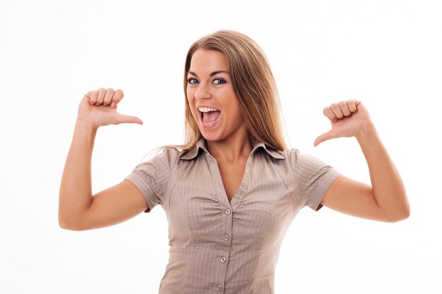 Young woman pointing to herself