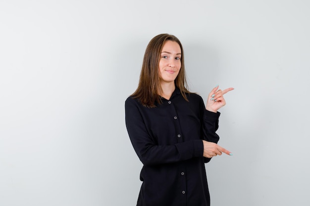 Young woman pointing right