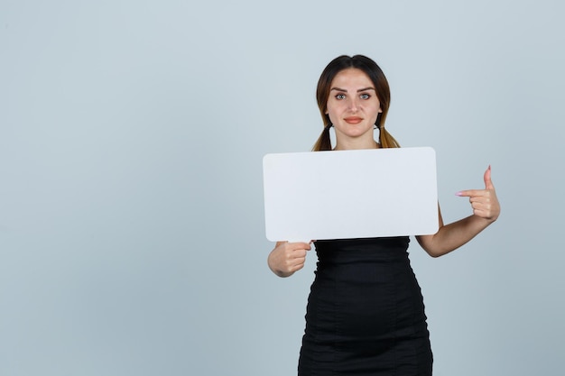 Young woman pointing at speech bubble