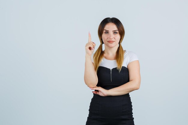 Young woman pointing up