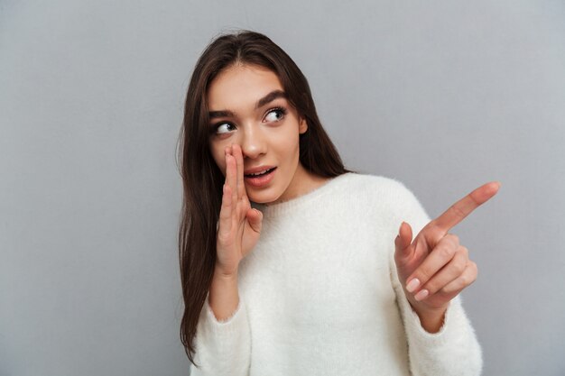 Young woman pointing with finger