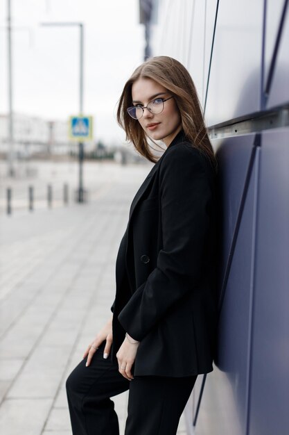 young woman portrait outdoor in black wear