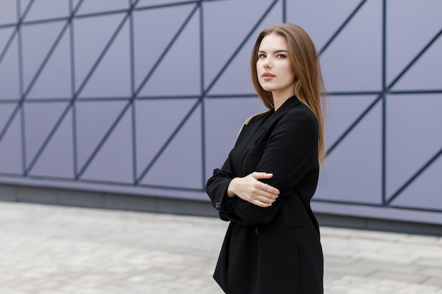 Young woman portrait in suit and glasses outdoor