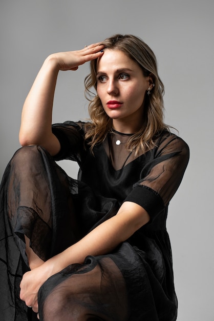 Young woman posing in black dress medium shot