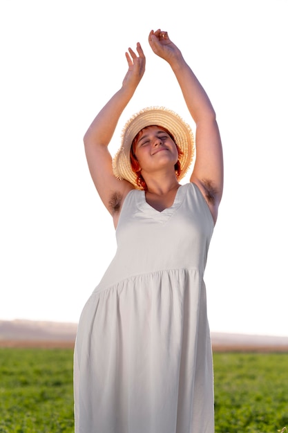 Young woman posing confidently and showing armpit hair