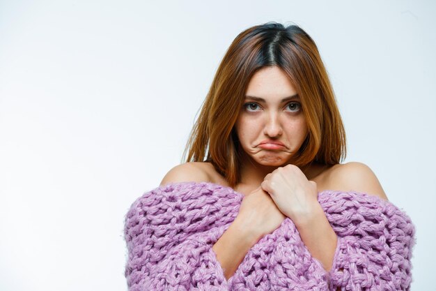 Young woman posing in knitwear and pouting lips