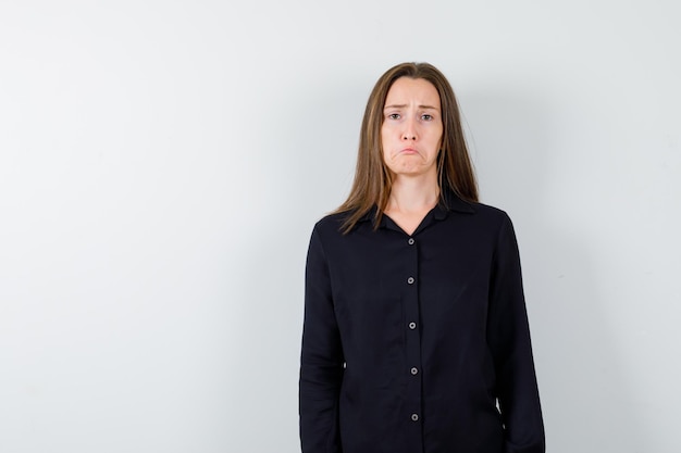 Young woman posing and looking disappointed