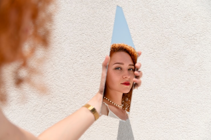 Free Photo young woman posing in a mirror shard