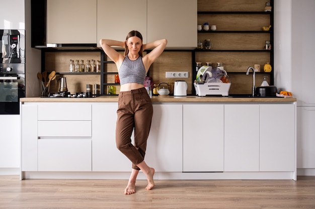 Young woman posing on modern kitchen