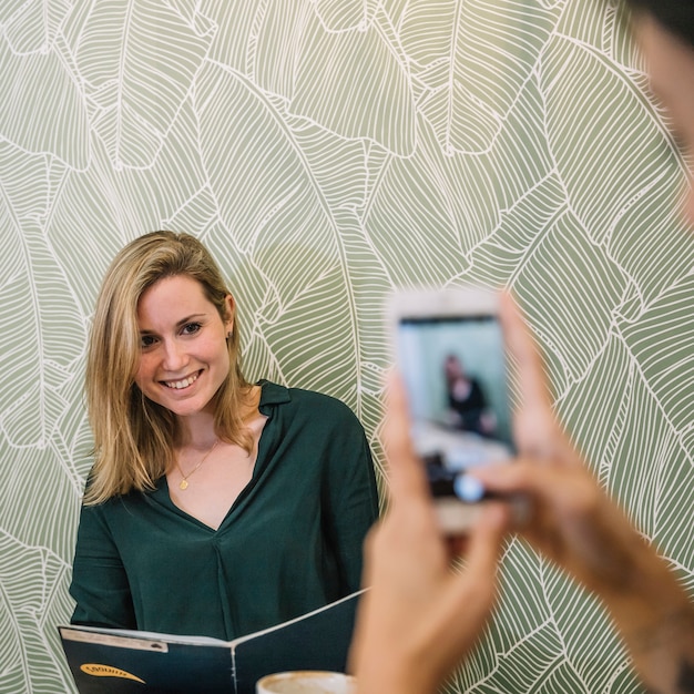 Free photo young woman posing for photo in cafe