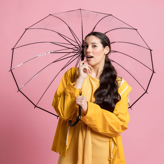 Young woman posing while holding an umbrella