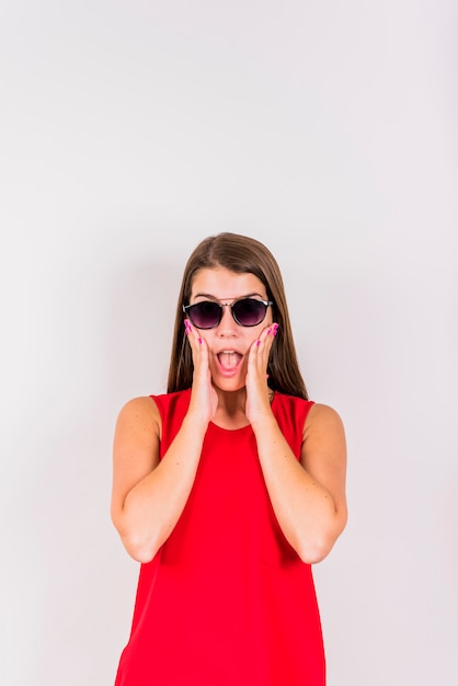 Young woman posing while surprising