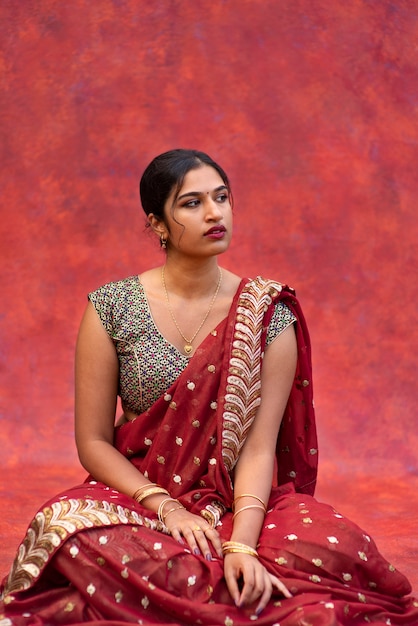 Young woman posing while wearing traditional sari garment