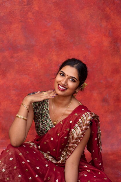 Young woman posing while wearing traditional sari garment