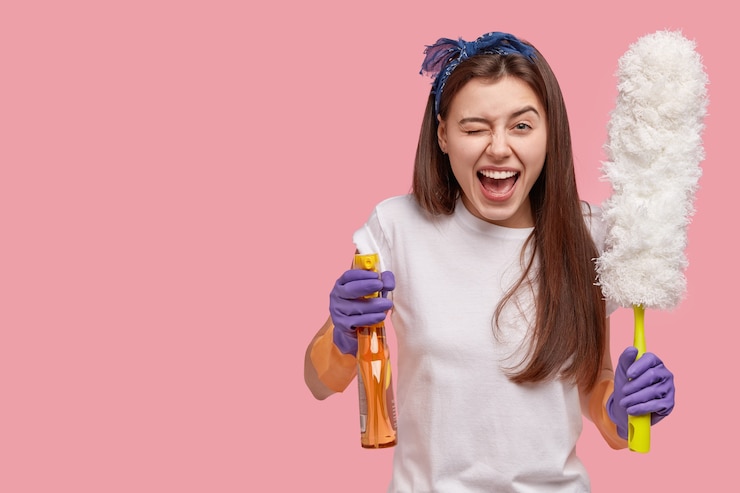Free Photo young woman posing with cleaning products