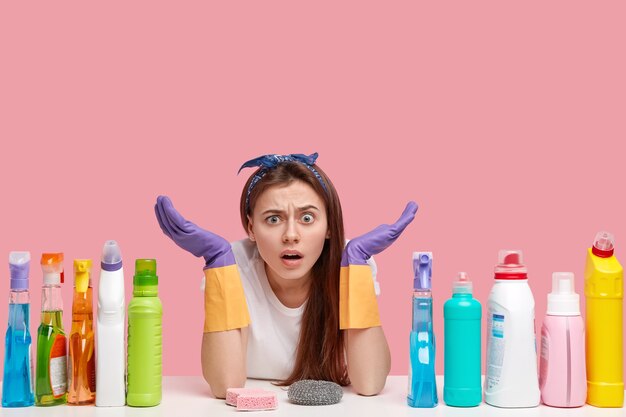 Young woman posing with cleaning products