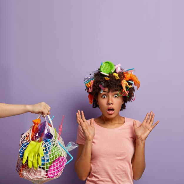 young woman posing with garbage in her hair