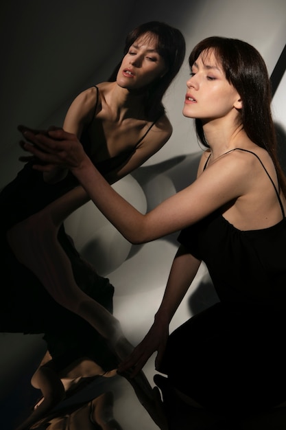 Young woman posing with mirror reflection