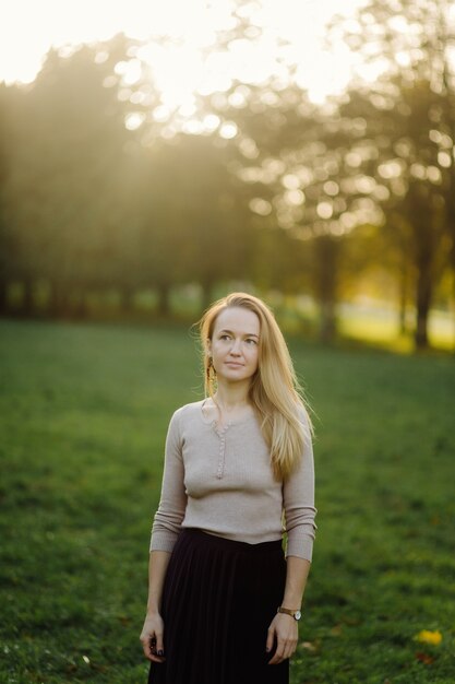 Young Woman Posing Over Yellow Leaves In The Autumn Park. Outdoor