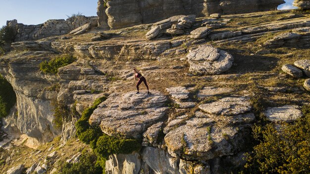 Young woman practicing yoga in nature