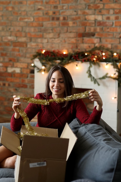 Free photo young woman preparing christmas decoration