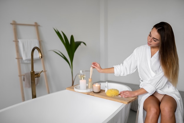 Free photo young woman preparing for her bath time