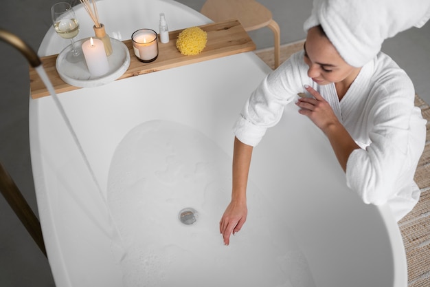 Free photo young woman preparing for her bath time