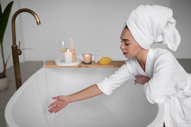 Young woman preparing for her bath time