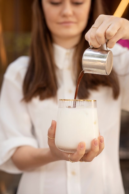 Young woman preparing iced coffee