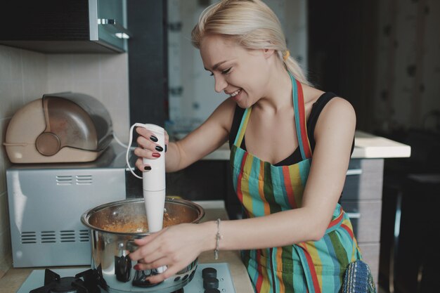 Young woman preparing pumpkin soup