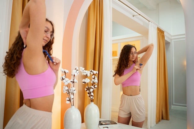 Free photo young woman preparing for shaving her body