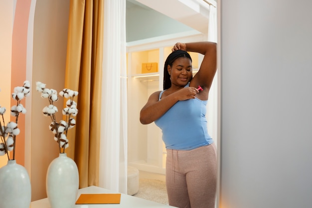 Free photo young woman preparing for shaving her body