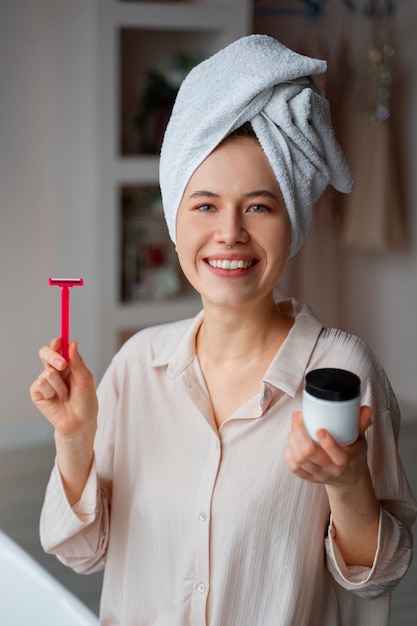 Free photo young woman preparing for shaving her body