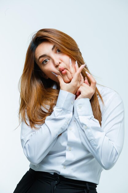 Young woman pressing cheeks with fingers