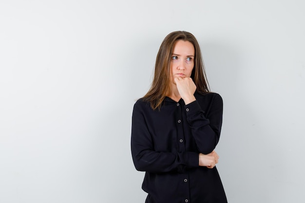 Young woman propping chin on fist