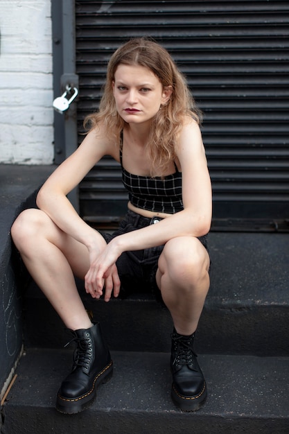 Young woman in punk clothes outdoors