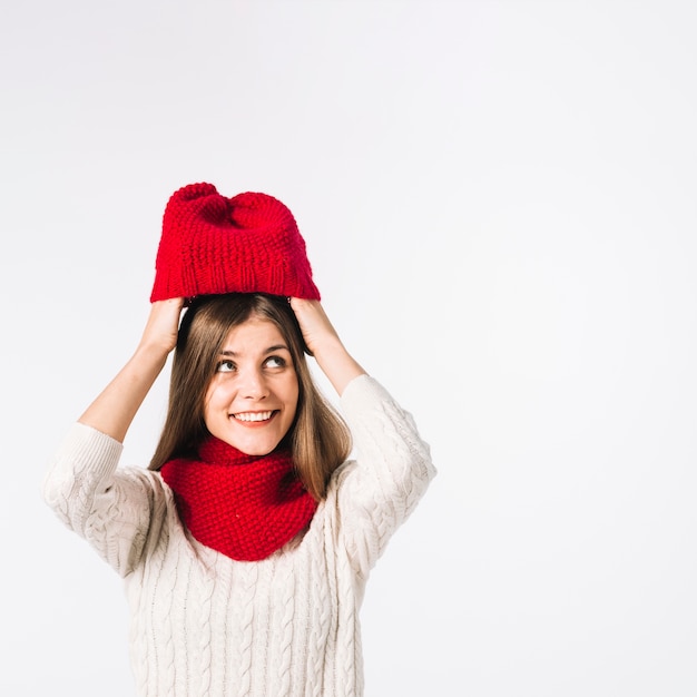 Young woman putting cap on