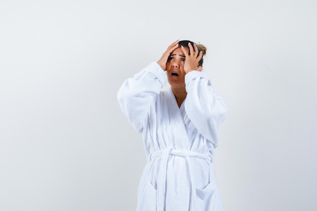 Young woman putting hands on head