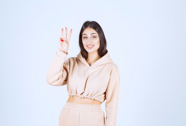 Young woman raising her hand to get noticed