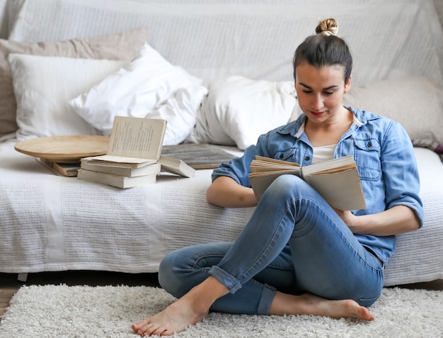 Молодая женщина читает книгу в уютной комнате