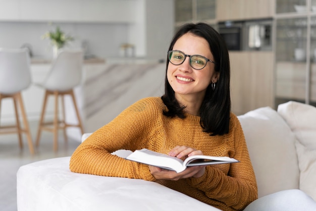 Young woman reading from a book at home