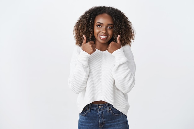 Young woman really likes plan and gives thumbs-up recommends