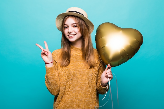 Young woman receives air baloon on anniversary celebration isolated over color wall