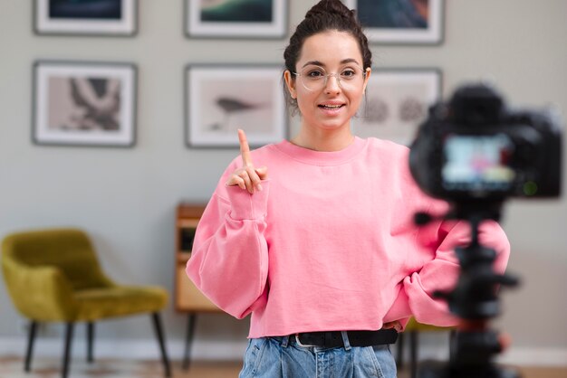 Young woman recording video at home