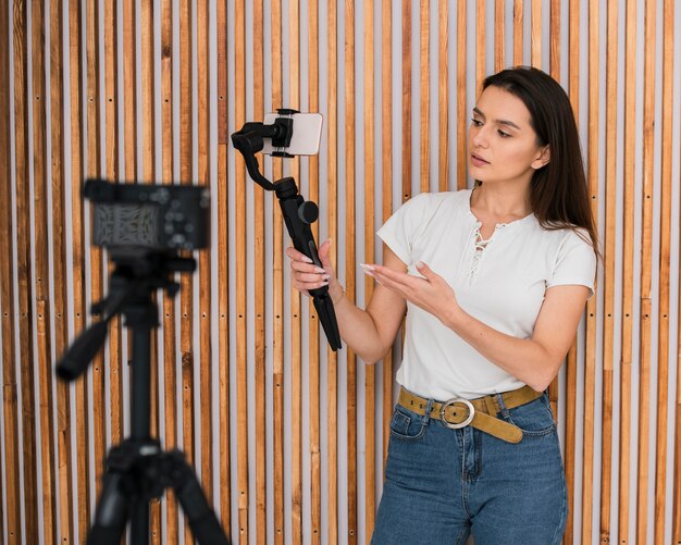 Young woman recording a video