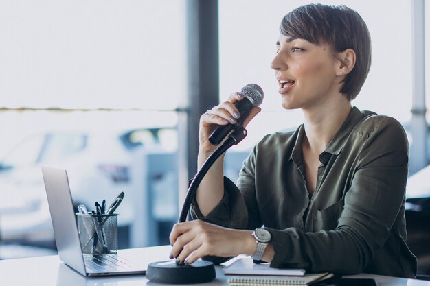 Young woman recording voice acting at studio