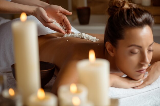 Young woman relaxing in spa salon.