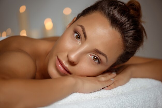 Young woman relaxing in spa salon.