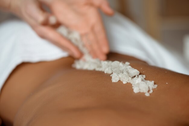 Young woman relaxing in spa salon.