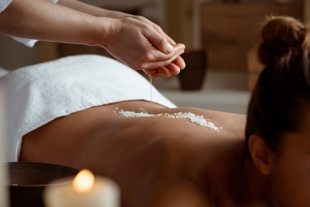 Young woman relaxing in spa salon.